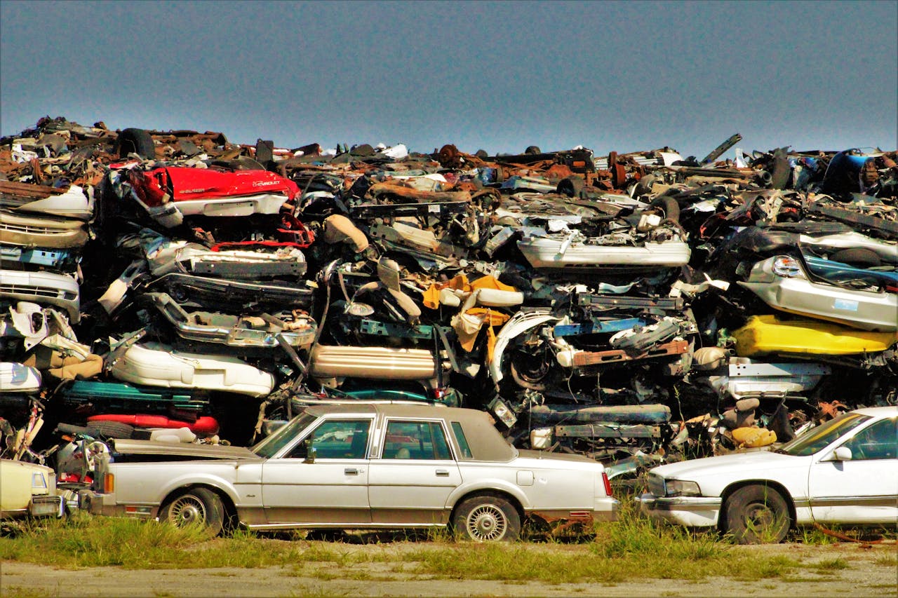 Mastering the First Impression: Your intriguing post title goes here A large stack of disposed vehicles in an outdoor junkyard.