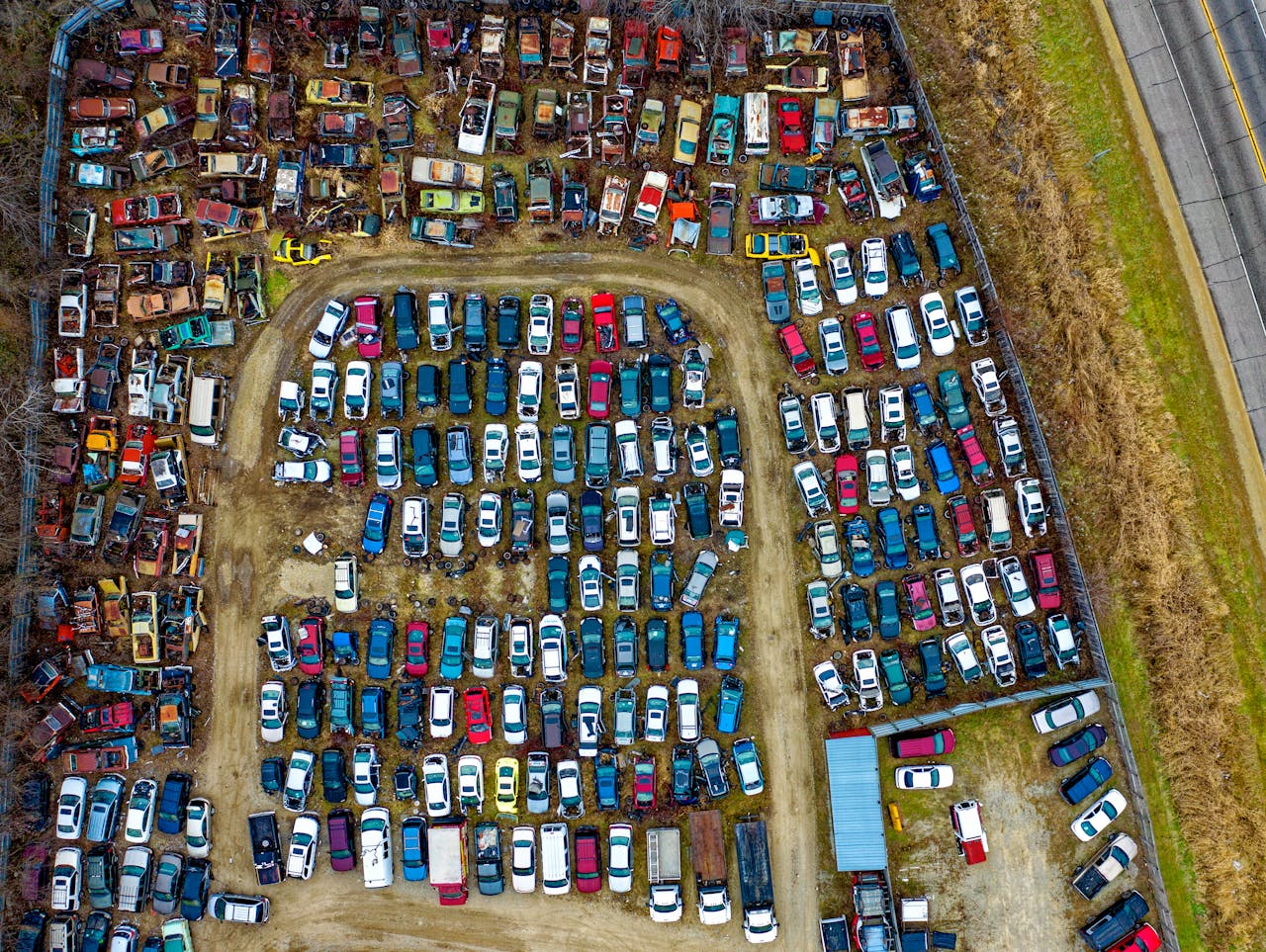 About Drone view of a sprawling car junkyard with vintage vehicles in Rochester, MN.