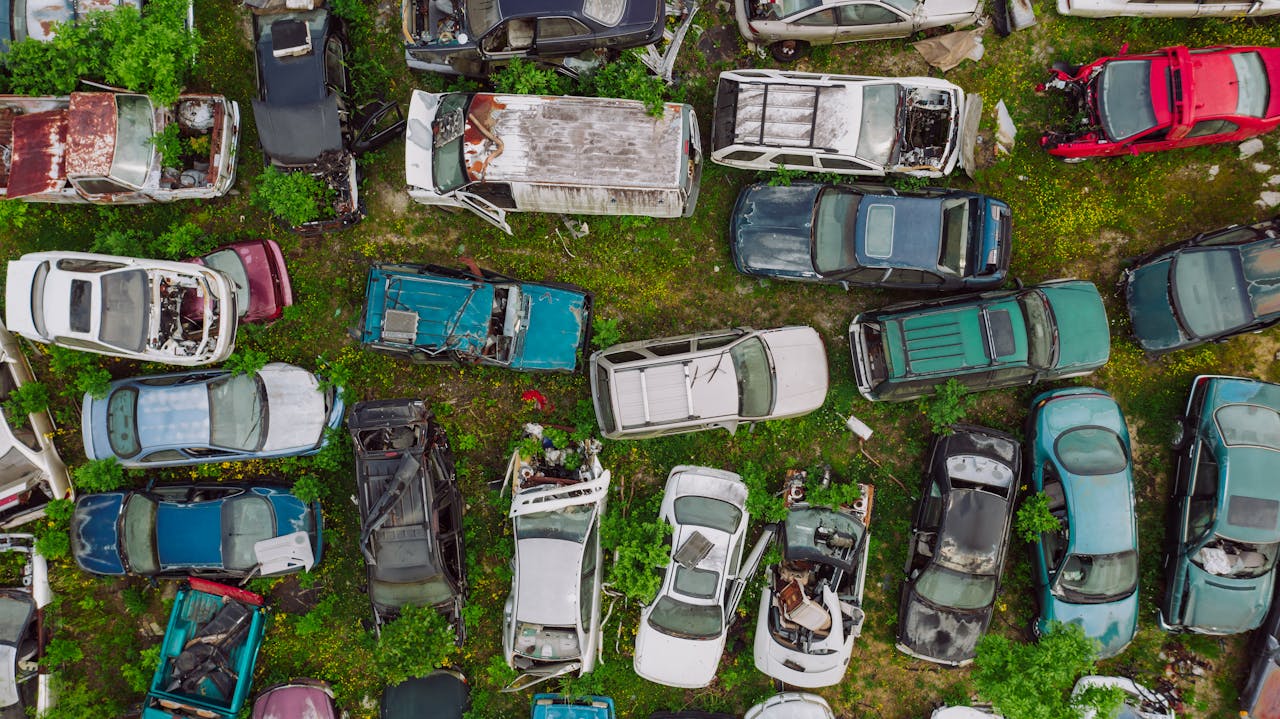 Crafting Captivating Headlines: Your awesome post title goes here Top view of various wrecked cars located in car dump on greenery in summer day